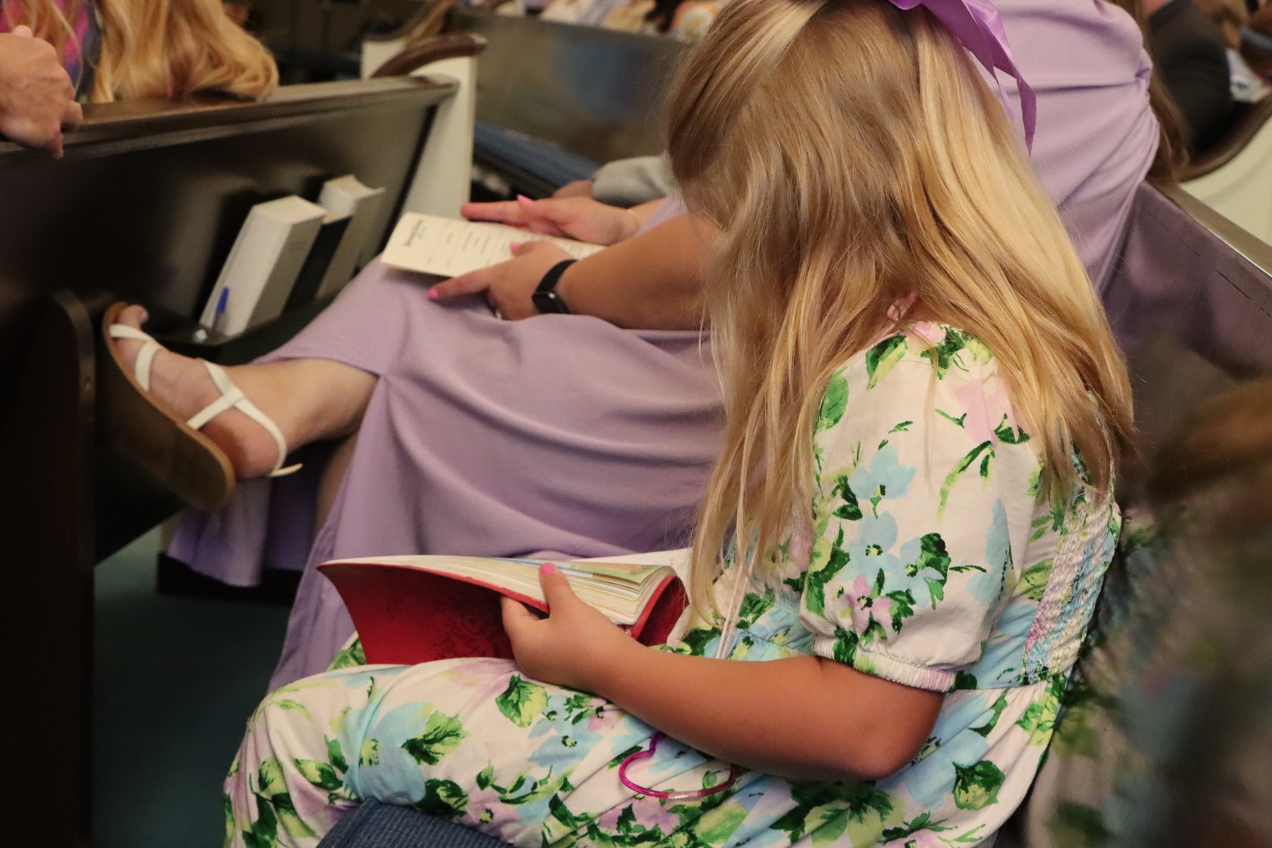 A child reading the Bible during worship